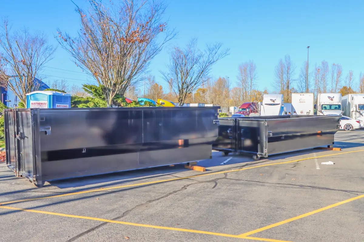 Professional dumpster rental service with roll-off container on residential driveway in Lee's Summit